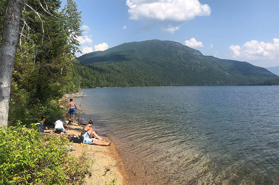 Group of people lakeside BC mounatin lake